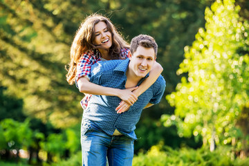 Lifestyle, happy couple of two play on a sunny day in the park