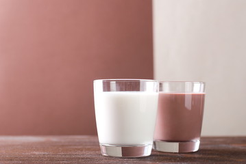 glass of white and chocolate milk on the table