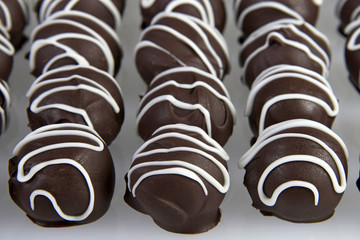 Chocolate Cake Balls with white candy melt accent stripping, side view