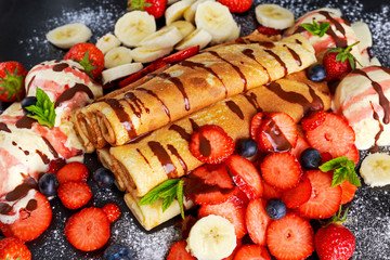 Sweet Rolled Pancakes with nutella, strawberry, blueberry, banana, ice cream.