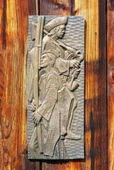 antique old style retro object assemblage on a wooden wall, rustic stile. Woodcarving musician.