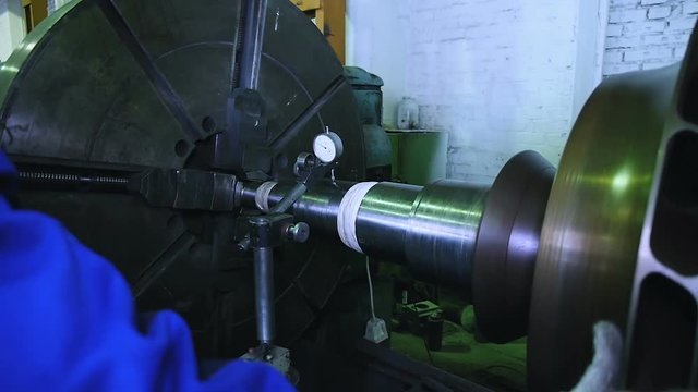 lathe operator in a factory for the production repair rotor for compressor turbine