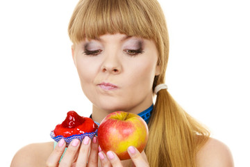 Woman choosing fruit or cake make dietary choice