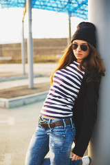 Fototapeta premium Outdoor fashion closeup portrait of nice pretty young hipster wo