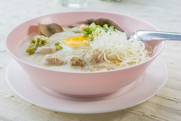 rice porridge, rice gruel or congee with pork, egg, liver,  delicious the traditional Chinese breakfast.