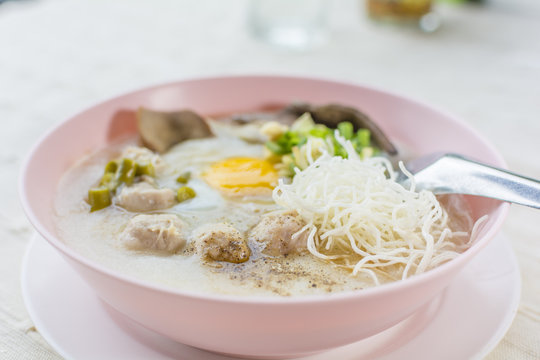 rice porridge, rice gruel or congee with pork, egg, liver,  delicious the traditional Chinese breakfast.