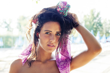 portrait of pretty woman wearing colored foulard in the hair nea