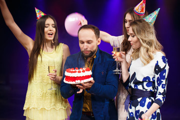 Happy birthday! Group of smiling friends gathered together with