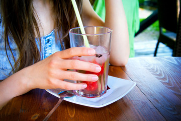 Glass of cold juice at hot summer day.