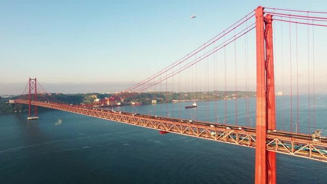Cars on Bridge Ponte 25 de Abril over the Tagus river in Lisbon, Portugal at morning aerial view