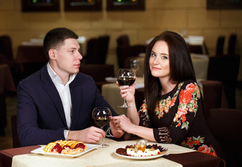 Couple toasting wineglasses in a luxury restaurant