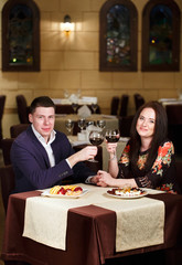 Couple toasting wineglasses in a luxury restaurant