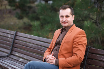 Fototapeta premium 40+ man with a problem of baldness is sitting on the bench.