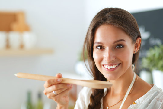 Cooking Woman In Kitchen With Wooden Spoon