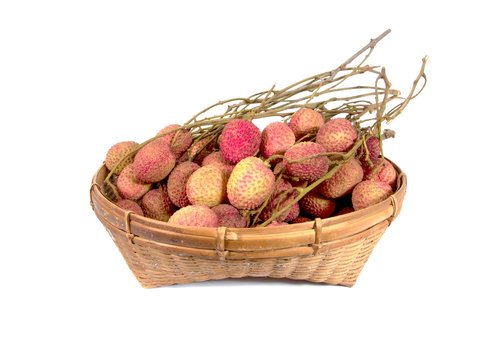 Lychees fruit in an old bamboo basket isolated on white backgrou
