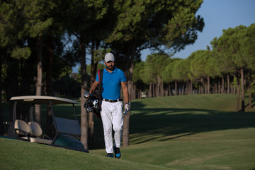 golfer  walking and carrying golf  bag