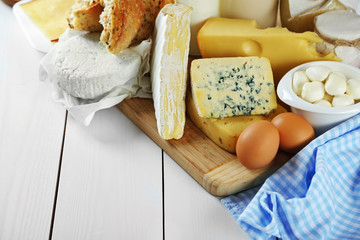 Set of fresh dairy products on white wooden table