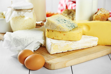 Set of fresh dairy products on white wooden table