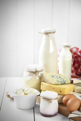 Set of fresh dairy products on white wooden table