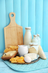 Set of fresh dairy products on blue wooden table, close up