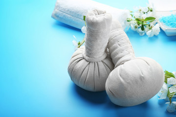 Spa treatment with blooming branch on blue background