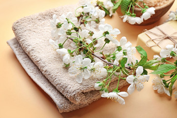 Obraz na płótnie Canvas Spa treatment with blooming branch on beige background