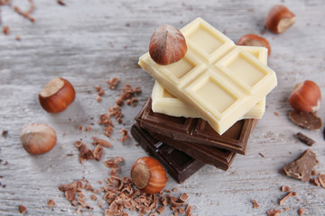 Mix of chocolate with nuts on wooden table
