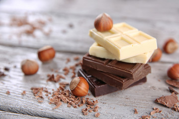 Mix of chocolate with nuts on wooden table