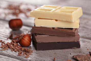 Mix of chocolate with nuts on wooden table
