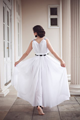 Fototapeta premium Pretty girl in long white dress