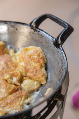 Fried egg Cooked in The pan -omelet Thai style. Selective Focus