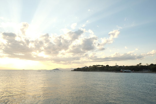 Sea Sunset in Aegina, with wievs to Kolonna ancient ruins, Greec