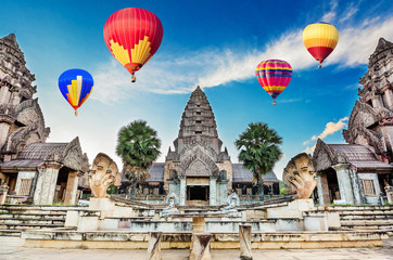 Hot-air balloons flying over blue sky at Ancient Bayon castle, Angkor Thom, Chiangrai, Thailand.