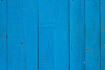 the surface of the wooden boards freshly painted in blue color