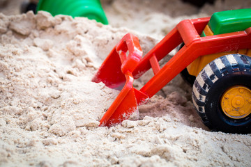 Fototapeta na wymiar Childrens toy car in sandbox