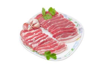 Sliced uncooked streaky pork belly bacon on a dish