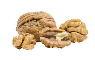 Walnut in their shell and several shelled kernels closeup