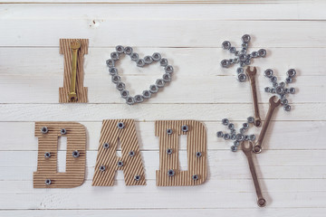 Fathers day background with cardboard letters and flower of nuts