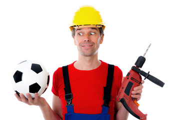 handcrafter with helmet and drilling machine and soccer ball