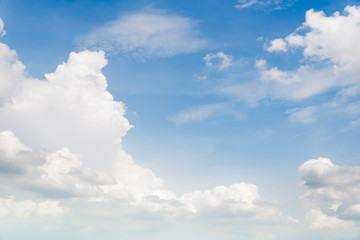 Blue sky background with white clouds.