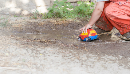 boy plays with a machine in a pool in the summer