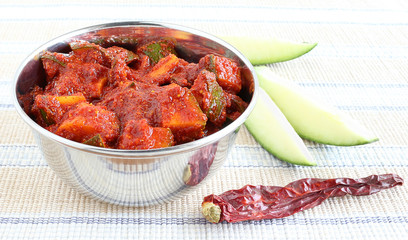 Home made mango pickle, a traditional Indian side dish, in a bowl.