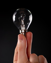 electric lamp in male fingers