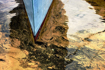 Oil spill from the ship - Texture of crude oil spill on the water.