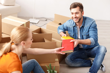 Young couple unpacking boxes