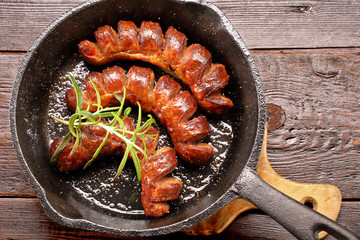 Grilled sausage in a frying pan