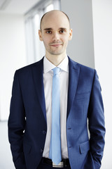 PORTRAIT OF CALM YOUNG BUSINESSMAN