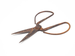 Old rusty scissors on white background