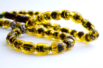 Closeup of an amber necklace on white background