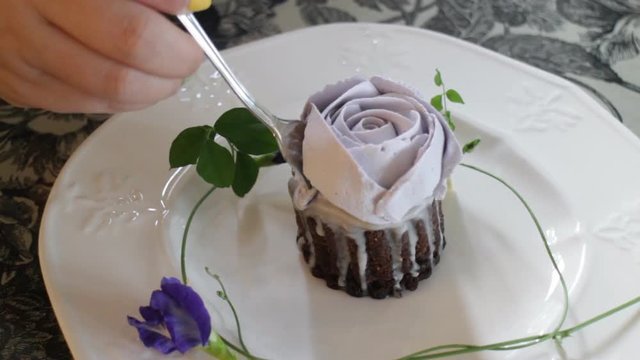 Woman enjoy having romantic rose cup cake, stock video